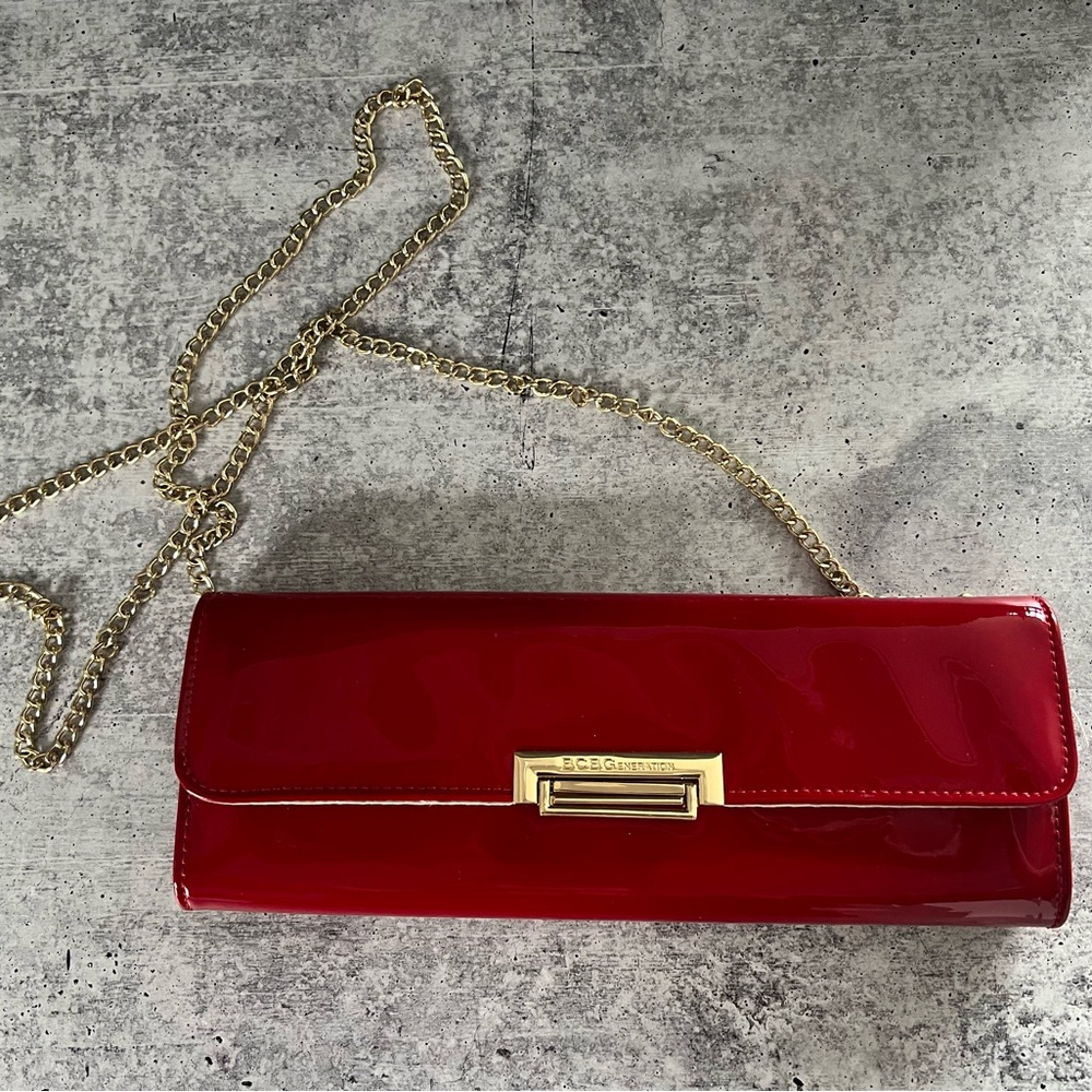 Gorgeous BCBG red patent clutch with gold strap. NWOT